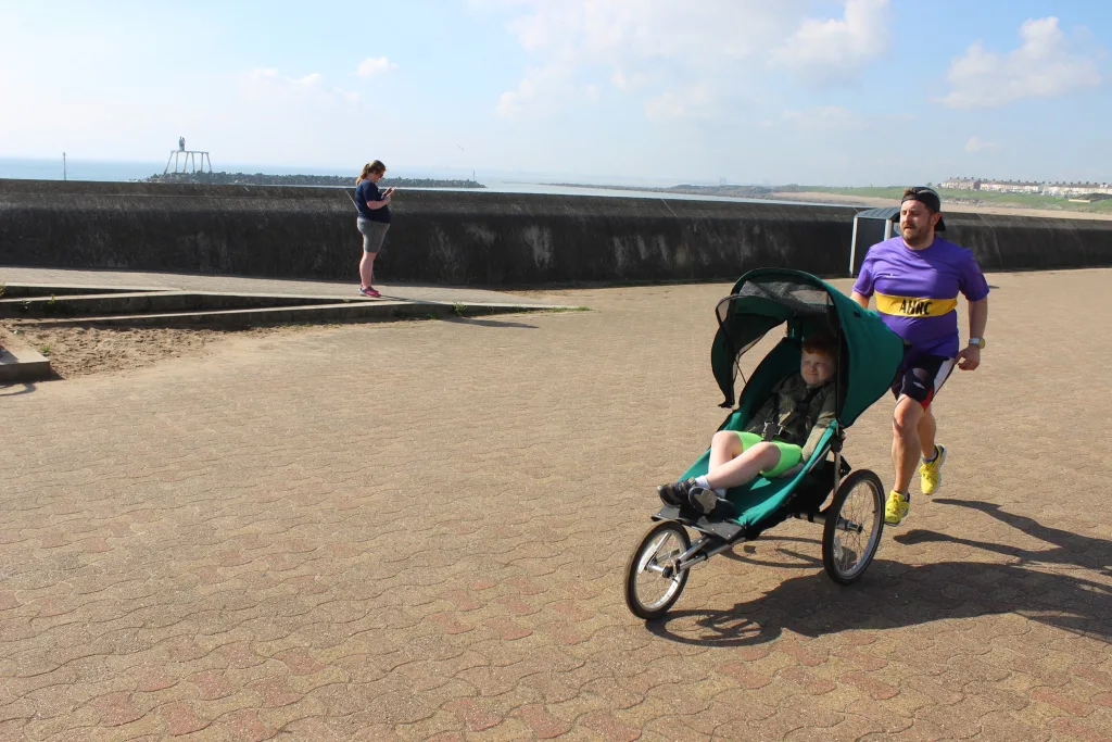 Running Dad pushing Kool Stride buggy at parkrun
