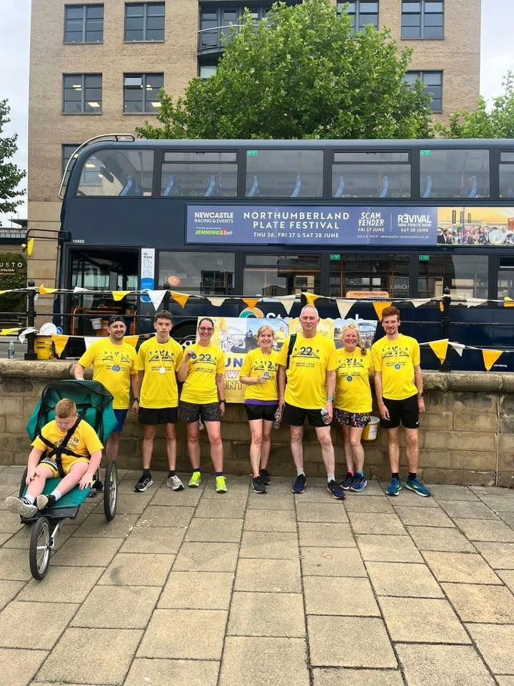 AHRC runners gather at the Sunshine Run with a specialist buggy